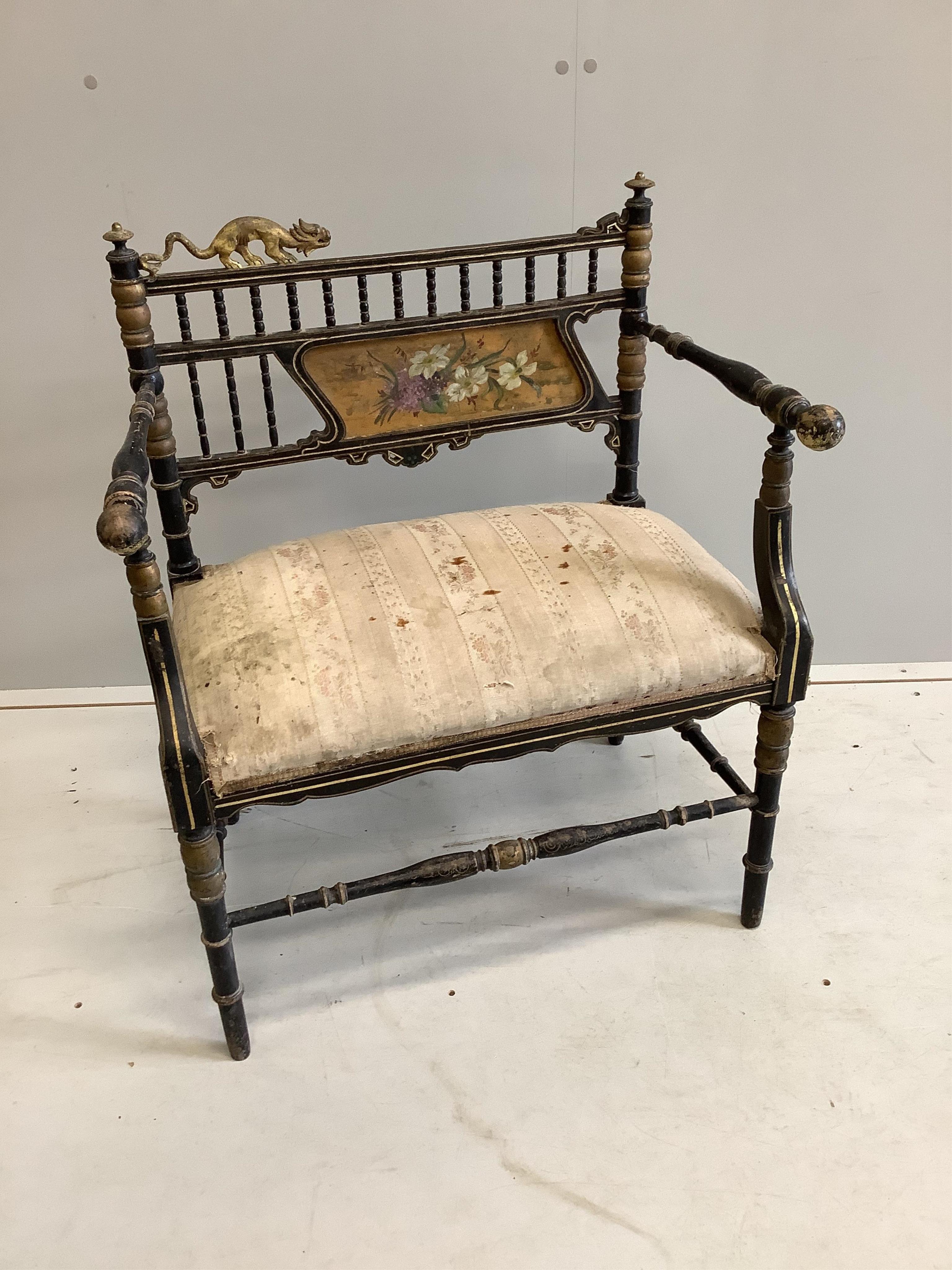 A Napoleon III Aesthetic movement ebonised salon chair, with gilt decoration and carved with the figure of a stylised beast on the cresting rail, width 67cm, height 81cm. Condition - poor to fair